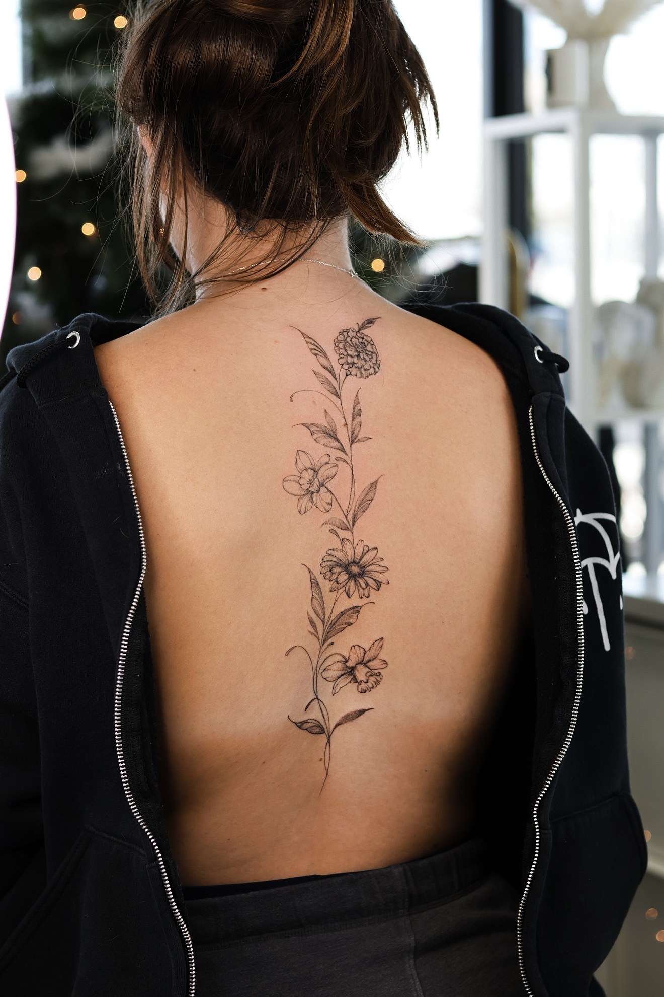 Fine line floral spine tattoo by On Point Fine Line Tattoo Studio, Woodridge IL